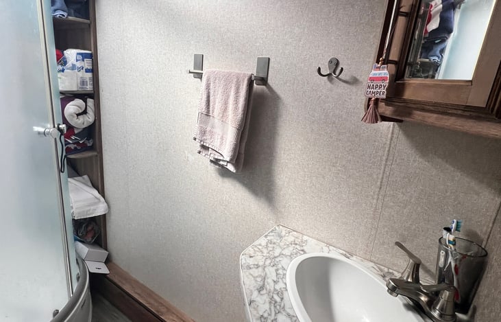 Full bathroom with a sink, vanity and mirrored cabinet.