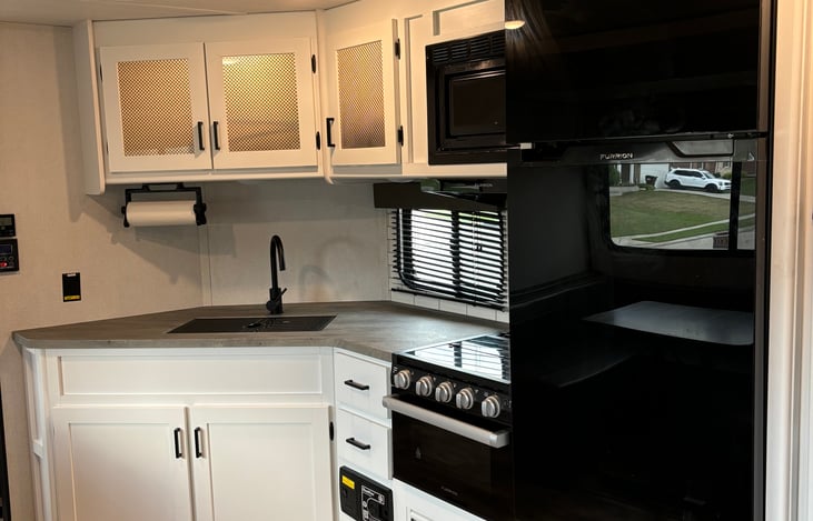 full size fridge and stocked cabinets