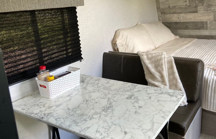 Storage under both bench seats, table folds down to be a twin mattress.