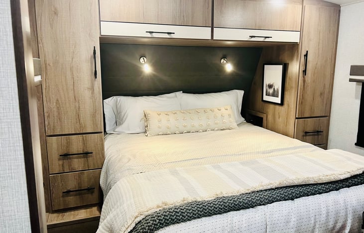 Private Bedroom with Sliding Door, Queen Size Bed, Mounted 32" TV, Dual Closets and Under Bed Storage.