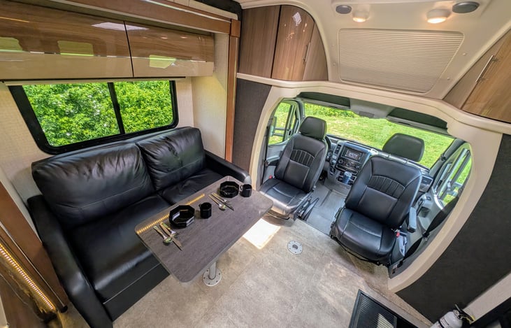 Classy and well-appointed interior with ample storage and premium materials throughout. Swing around captain's chairs and 2 positions for the dining table create a comfortable and flexible environment