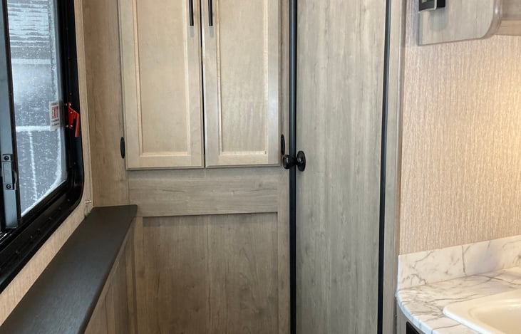 Pantry closet in the hall that leads to the Primary Bedroom.
