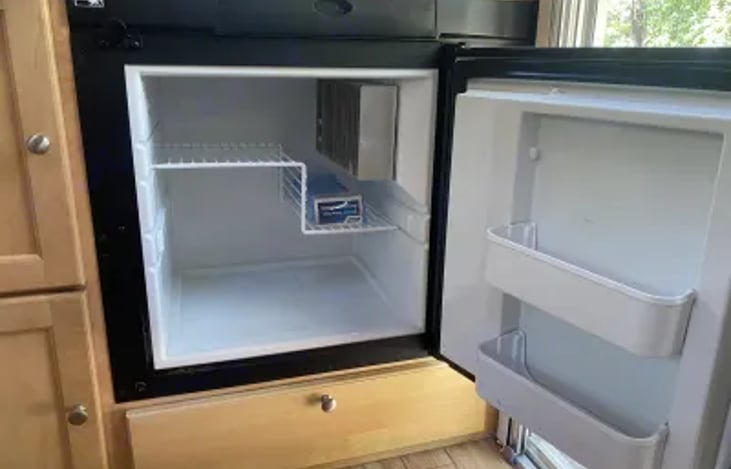 Refrigerator powered by either electric or propane.