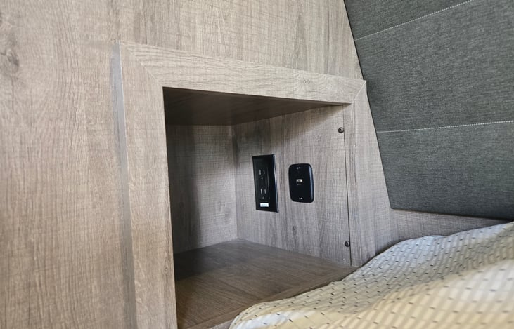Each side of the bed has a cubby with electric outlet and USB ports.