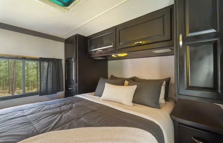 Festival ready comfort — unwind after the party in this soft, clean RV bedroom designed for rest and recharge