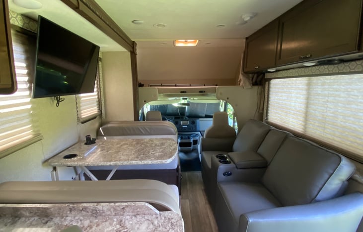 Comfy reclining chairs, slideout dining area, large TV, large bed on top of cabin for 2