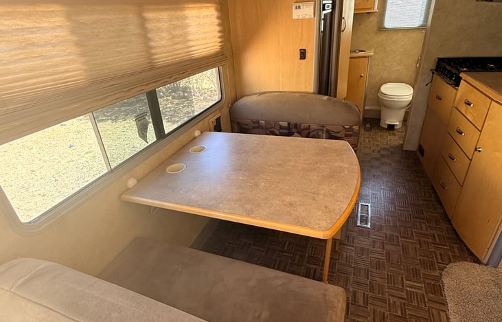 Cozy dining space by day, easily converts into an extra sleeping area at night 🍽️➡️🛏️