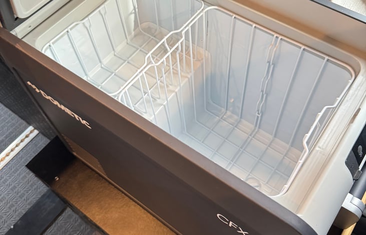 The van includes a high-performance CFX3 45 fridge—compact yet spacious—keeping your food and drinks fresh and cool with easy access for all your adventures.