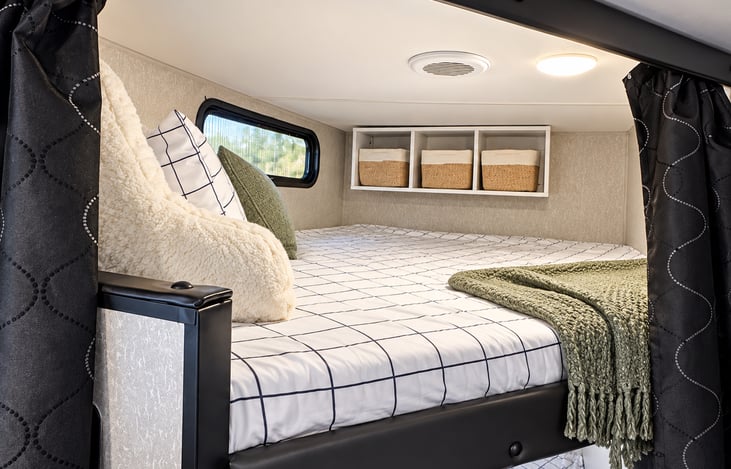 Top Bunk with storage. We do have a cover installed over the window.