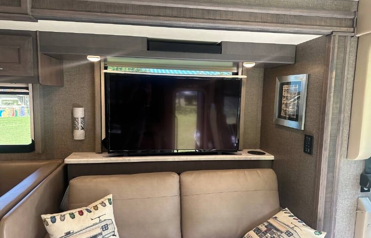 48" TV in living room that can be lowered/hidden at the touch of a button....