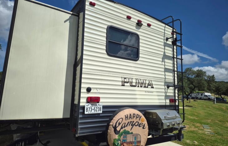 Propane grill mounted on the back of RV.