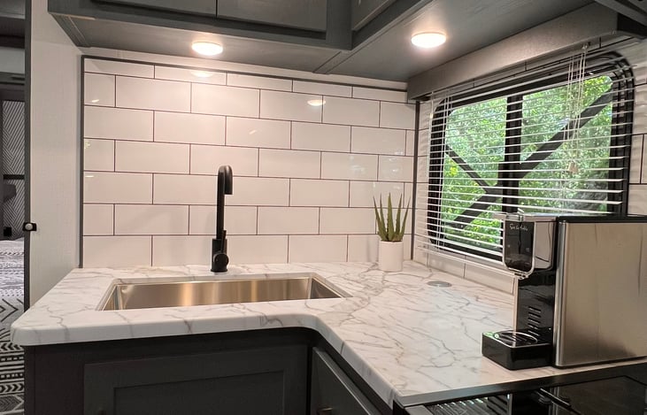 A Nespresso OL espresso machine is provided for your use. Pods are available at most grocery stores. Cookware, utensils and plastic serving ware are provided.