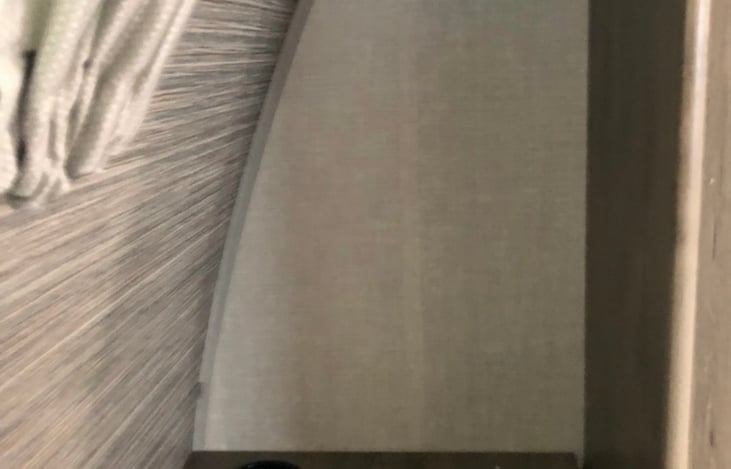 Nice storage cubby next to king bed.