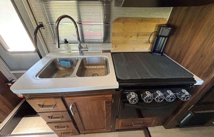 Double sink, gas stove/oven, coffee maker.