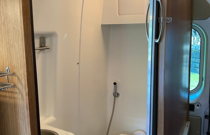 Bathroom with flush toilet & shower