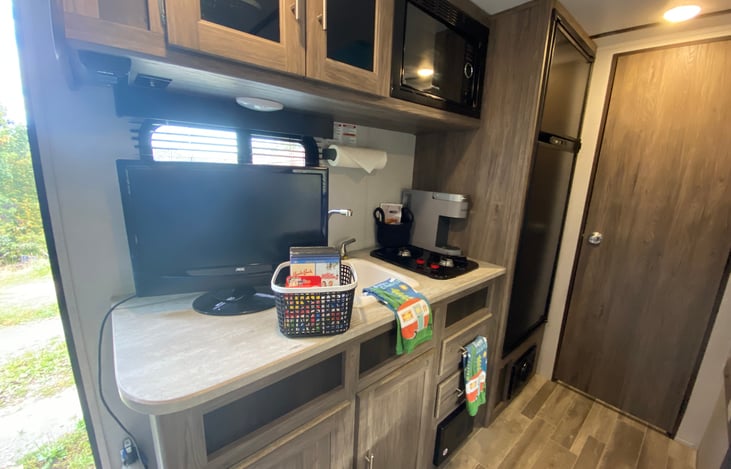 Tv/DVD player with a selection of DVDs and games.