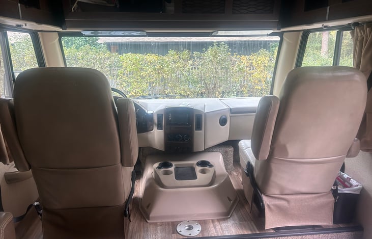 Comfy captains chairs that swivel. There is also an oval table that you can set up between them and a bunk above that can be lowered for use.