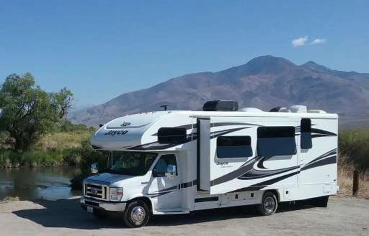 Pivot parked next to California hills.