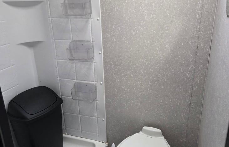 Shower (shower curtain is just put away but I can attach it before your stay!) Storage for toiletries on the wall.