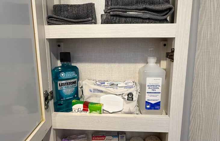 Medicine cabinet with towels and toiletries.