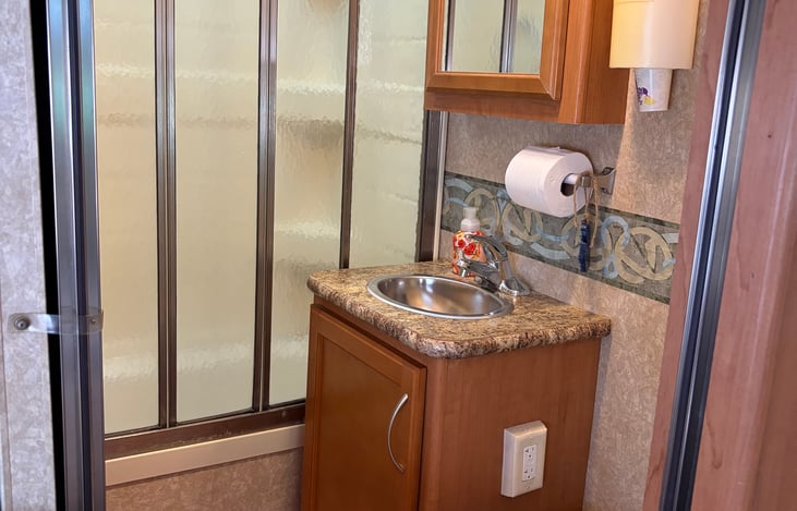 Full bathroom with foot pedal flush toilet.