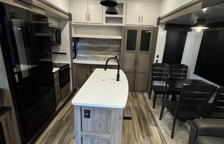 Kitchen, island, sink, four person table.