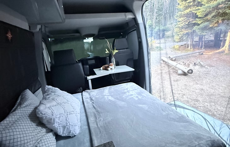 Bench converts into a bed with a side table.