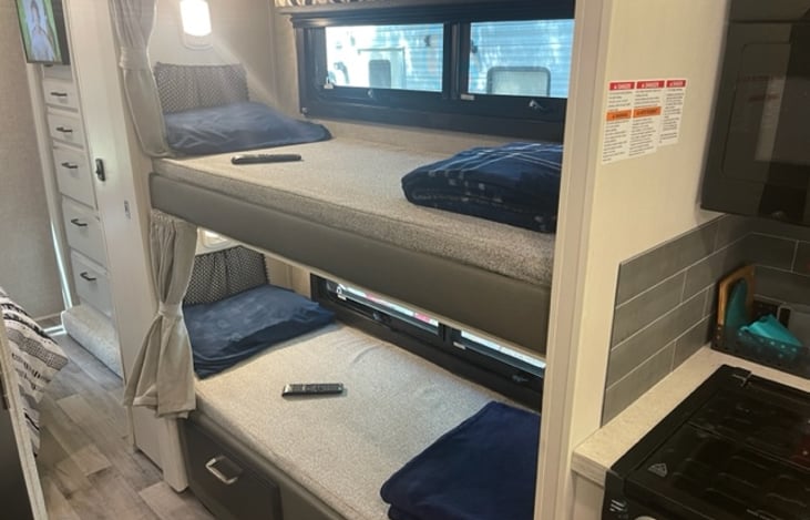 Bunk beds with individual lighting, TV, and 110 outlets in each.