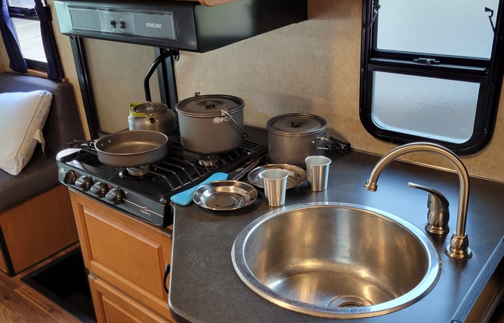 Full kitchen set with pots, pans, utensils, cups, bowls, knifes and cutting board