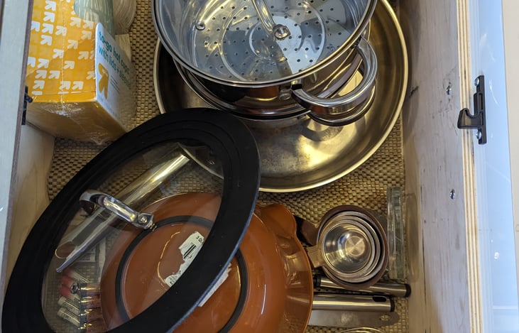 Kitchen drawer with pots and pans and other cooking tools