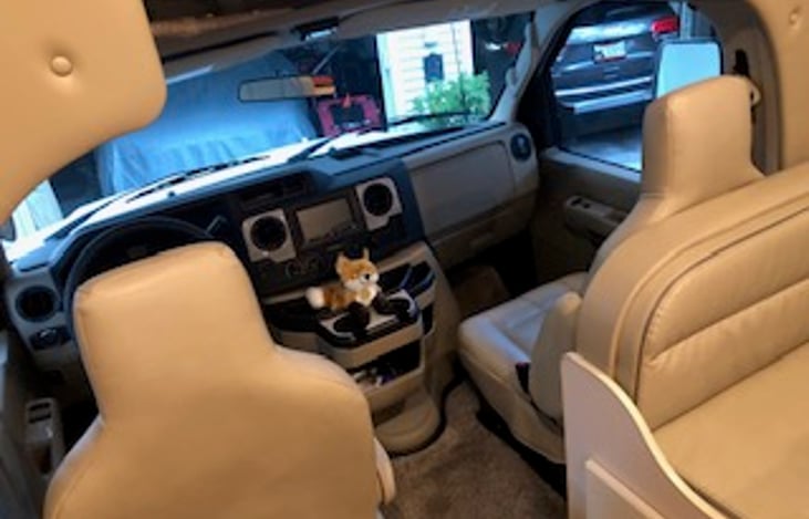 Comfortable chairs for the road. Rear view back up camera along with side view cameras that activate with the turn signals on.