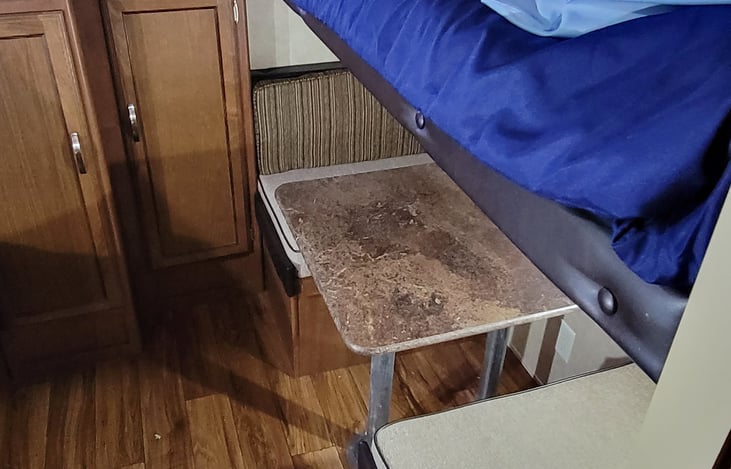 Bunkhouse dining area also comes down into a bed.