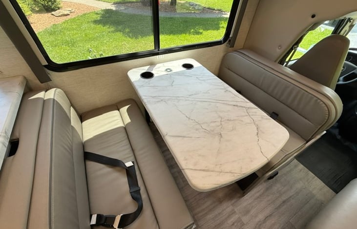 Dinette area with two seatbelts and USB charging ports.