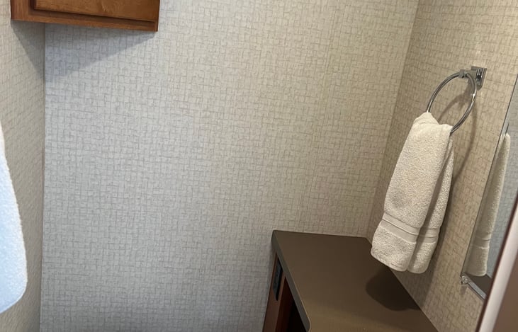 The toilet and sink have a private door separate from the shower so multiple people can use the bath at a time.