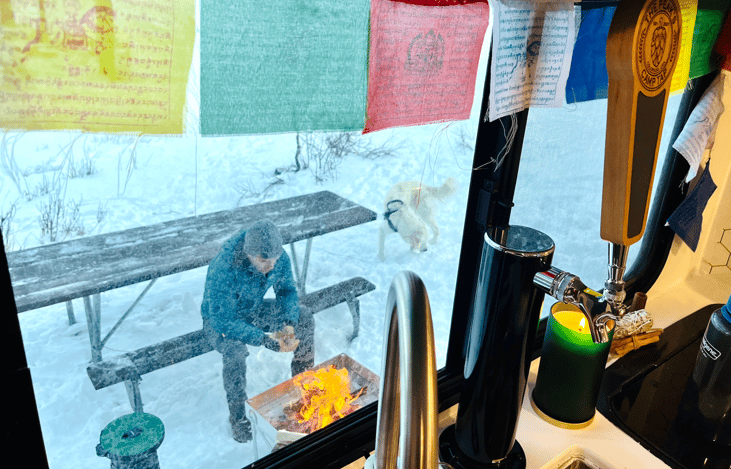 Outdoor table, love-seat, and enclosed fire burning pit included