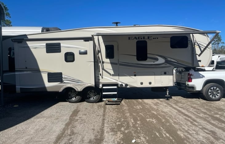 Passenger side exterior with one slide, awning and entry.