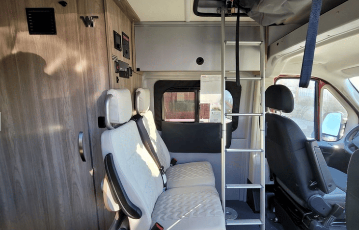 Ladder to Rooftop!
Ladder leads to a pop-up sleeping area for 2. 6 seatbelts: driver, passgr, 2 seats mid, 2 seats in rear. Incl: pedestal table and swivel chairs