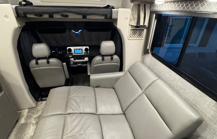 View of loveseat with both seats in the reclined position while the side slide is fully extended. This could serve as another sleeping area, although the recliners do not go fully flat.