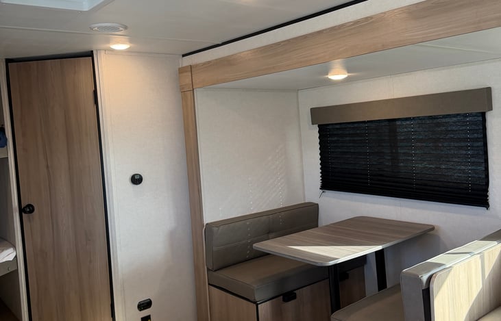 Comfortable dining dinette and living space—perfect for enjoying family meals, playing games, or relaxing after a day outdoors.