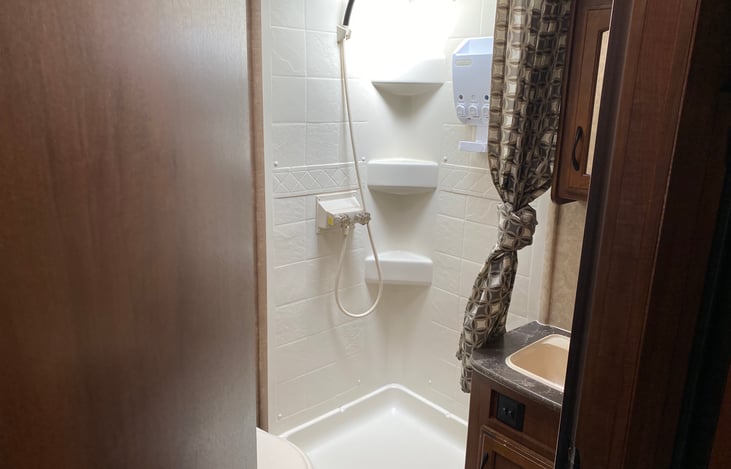 The full bathroom features a separate toilet and shower area along with a full sink and vanity.  The shower area gives plenty of space to stand up straight and rotate your body.