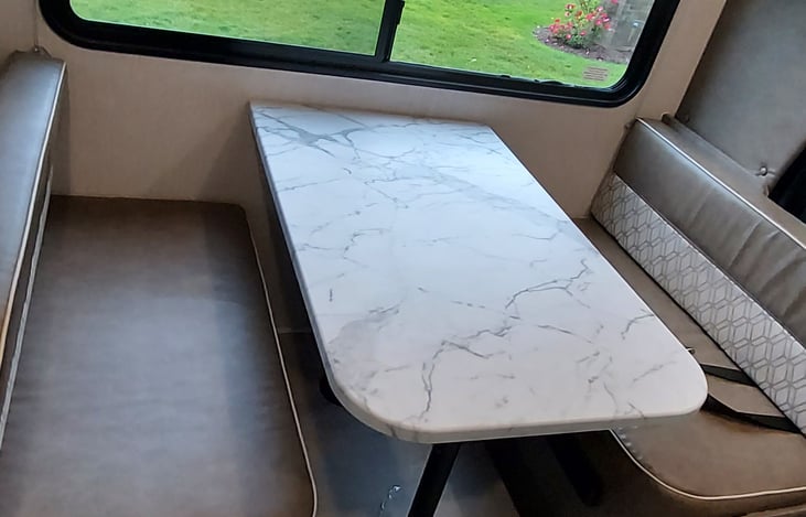 Dinette that folds down into a bed. Also has seatbelts on either side