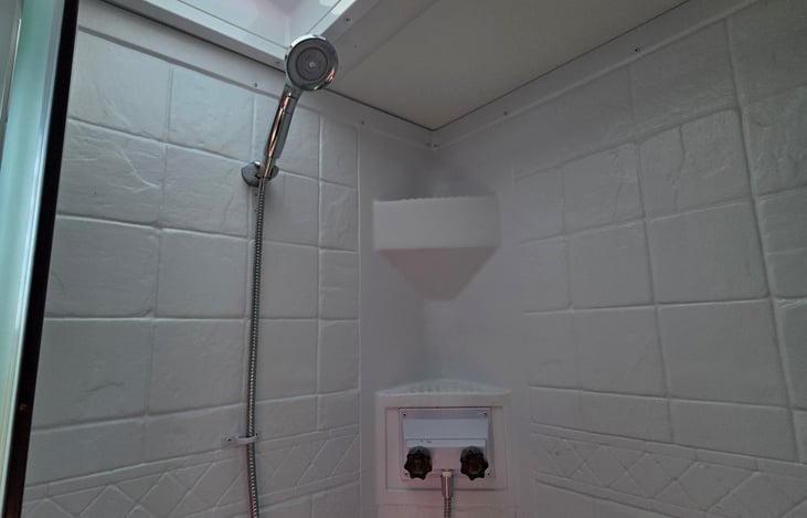 Upgraded shower head, skylight, and overhead lighting