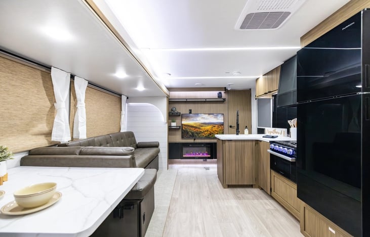 Spacious U-Shaped dinnete and couches that convert to beds for additional sleeping spots. Spacious full sized refrigerator inside and small refrigerator in outside kitchen.