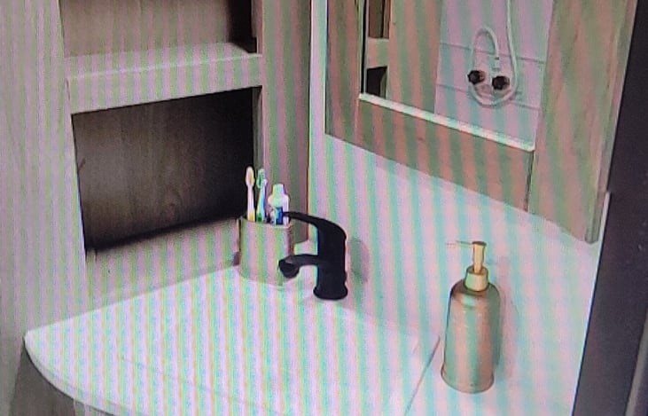 bathroom sink with storage shelves