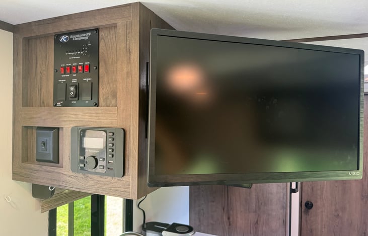 Fresh, black and grey tank status lights as well as awning control, Bluetooth entertainment system and smart TV.