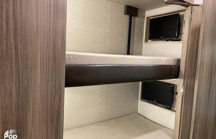 Two bunks with closing pocket door for noise control or privacy.