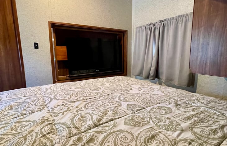 TV swivels so it can be enjoyed from the living room or master bedroom.