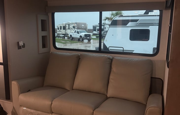 Reclining sofa, middle section folds out with drink holders and electrical/USB outlet