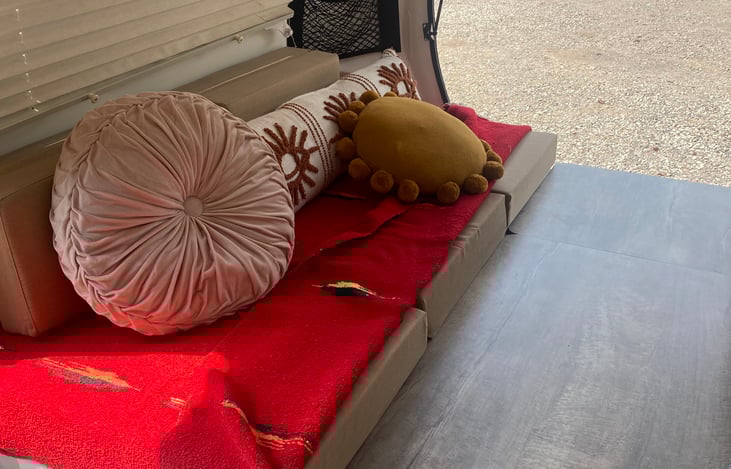 Bed converts to table; pictured are the middle cushions removed to reveal the table pieces that pop out