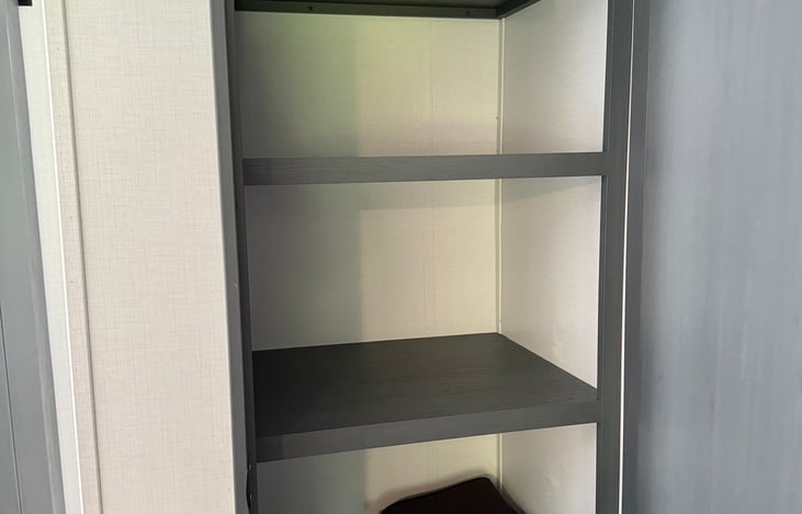 Spacious storage closet next to bathroom
